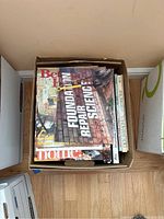 Box filled with assorted books and magazines on home design, improvement, and gardening.