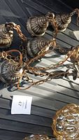 Ornate metal canopy pieces and chain links laid out
