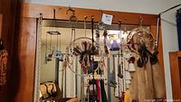 Two large dream catchers and other hanging items mounted on a wall hanger, showing the overall lot composition