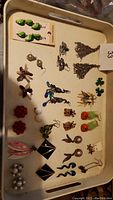 Tray with various clip-on and pierced fashion earrings in different colors and styles