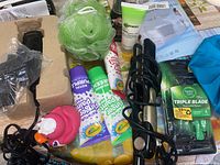 Photo showing assortment of haircare and bathroom items including clippers, creams, sponge, razors, and styling tools