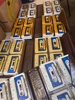 Multiple binders containing rows of cassette tapes labeled 'Bible Study Tape' in blue, white, and gold colors.