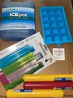 Photo showing Cryopak Ice Pak, Kolorae silicone 15-cube ice tray, and set of 3 colorful reusable bottle chillers in packaging