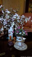 Image showing Roseville candle holders, Gorham glass flowers in floral arrangments, porcelain Asian vase, decorative bowl, and etched crystal paperweights on wood table