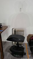 Black AeroGarden indoor garden grower unit with curved top and base control panel