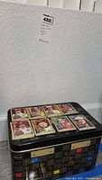 Full view of decorated NASCAR metal tin box and multiple collectible metal cards arranged on top
