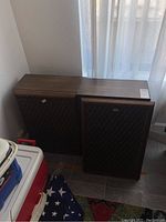 Two Sansui speakers side by side with grille covers on