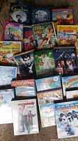 Full lot view of all 20 kids DVDs arranged on floor showing titles and condition