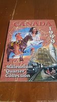 Front cover of the Canadian Millennium Quarter Collection 1999 folder showing artwork including a Canadian Indigenous person, a sailing ship, and train.