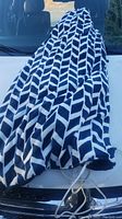 Blue and white patterned electric blanket laid out showing fabric pattern and control cord