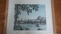 Framed print artwork showing Ottawa skyline with trees and river in foreground.