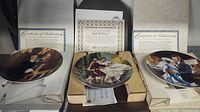 Three collectible plates each in original packaging with Certificates of Authenticity, showing scenes from 'Gone With The Wind' and 'The King and I'.