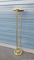 Full view of the brass mid-century standing lamp showing its height and base design.