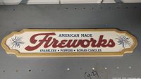 Full view of the wooden fireworks sign with text and design shown.