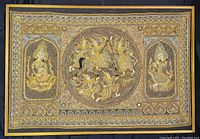 Full view of large Indonesian textile art in gold-coloured frame with intricate embossed detailing. The piece measures approximately 53 inches by 36 inches.