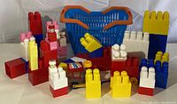 Front view of assembled Megablocks with toy vehicle and basket