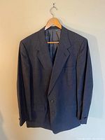 Front view of dark blue checked suit jacket showing collar, lapels, and two-button closure.