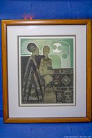 Framed full view of the numbered print showing three stylized human figures with geometric patterns.