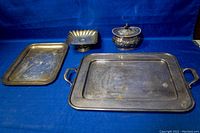 Photo showing the entire set including two trays, pedestal candy dish, and lidded canister against blue backdrop