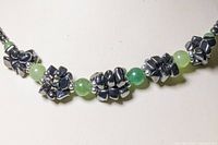 Close-up view of the clustered black onyx stone chips alternating with green jade beads.