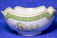 Side view of the Japanese ceramic centerpiece bowl showing floral and bird hand painted design with scalloped gold trimmed edge and green decorative band.