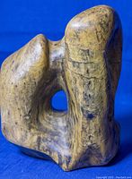 Front and side view of vintage abstract soapstone sculpture showing its shape, texture and condition.