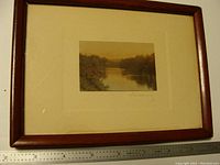 Front view of framed photograph showing wood frame, mat, image and ruler for scale