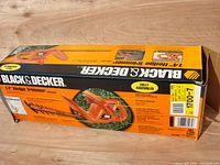 Box packaging showing brand, model TR1400, and product details for the 14 inch hedge trimmer.