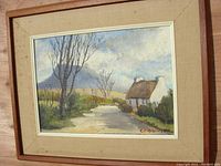 Full view of framed oil painting showing the landscape scene and wooden frame.