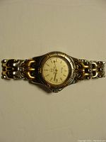 Full view of Bulova Marine Star two tone wristwatch showing dial, bezel and metal link bracelet.