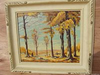 Front view of the framed oil painting depicting a tree landscape with autumn colors.