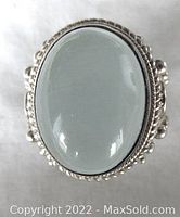 Close-up front view of large oval moonstone set in detailed beaded sterling silver ring.