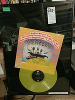 Framed yellow vinyl record with Magical Mystery Tour album cover and display plaque.
