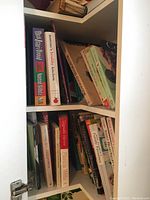 Shelves of assorted cook books showing titles related to healthy cooking, Indian cuisine, diabetes recipes, and vegetable dishes.