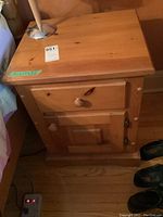 Vintage pine night table showing top, drawer, wooden knob, and cabinet door closed.