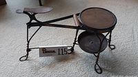 Side angle showing full chair with footrest, wooden seat, and metal tray under seat