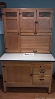 Frontal view of entire oak cabinet showing upper and lower sections