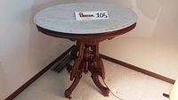 Full front view displaying complete table with marble top and wooden base together.