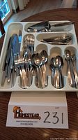 Photo of full Community Stainless flatware set arranged in tray, showing various utensils neatly organized.
