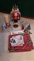 Photo showing the full lot including nutcracker, snowman, angels, ornaments, and linens on a carpeted floor