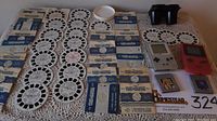 Photo showing full collection including multiple View-Master reels in original sleeves, two Game Boys (one silver original, one red Game Boy Color), two Tetris game cartridges, and the black View-Master viewer.