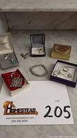 Overview of all gold and sterling silver jewelry on marble surface