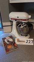 White KitchenAid Ultra Power KSM90 stand mixer with bowl, close-up side angle showing control panel and attached beaters.