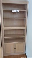 Front view of Lochner Woodworking oak wood bookcase cabinet showing five visible shelves and lower cabinet with two doors