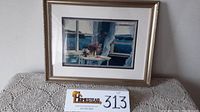 Framed signed and numbered print titled 'Island Breeze' by Randy Van Beek on a crocheted table cover with a lot number tag.