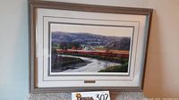 Full view of framed limited edition print with landscape showing river and fields with farm buildings in morning light.