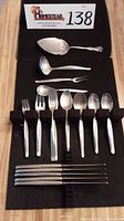 Overall view of all flatware on black display mat