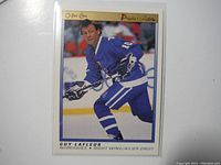 Single close-up photo of a Guy Lafleur hockey card from 1990-91 OPC Premier series showing player in blue Toronto Maple Leafs uniform.