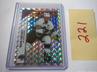 Front view of 1994 Panini Prizm Special Insert Wayne Gretzky hockey sticker in protective case with holographic prism background and player image.