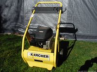 Front view of the yellow Kärcher cart with black Briggs & Stratton motor mounted.